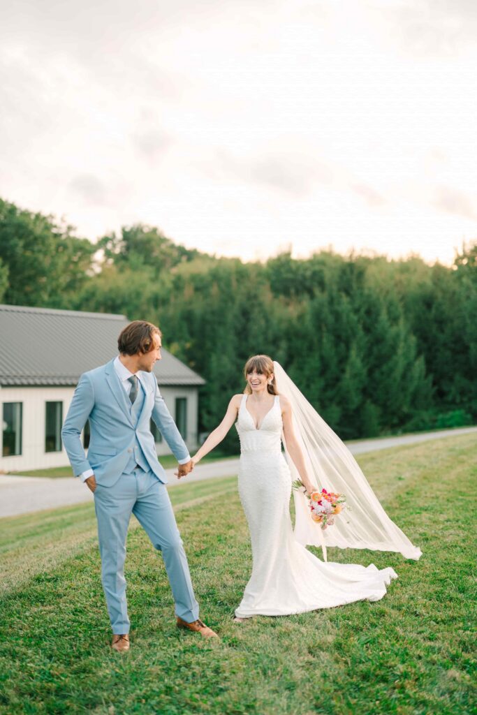 Couple walking by the pond at The Wellspring on their wedding day