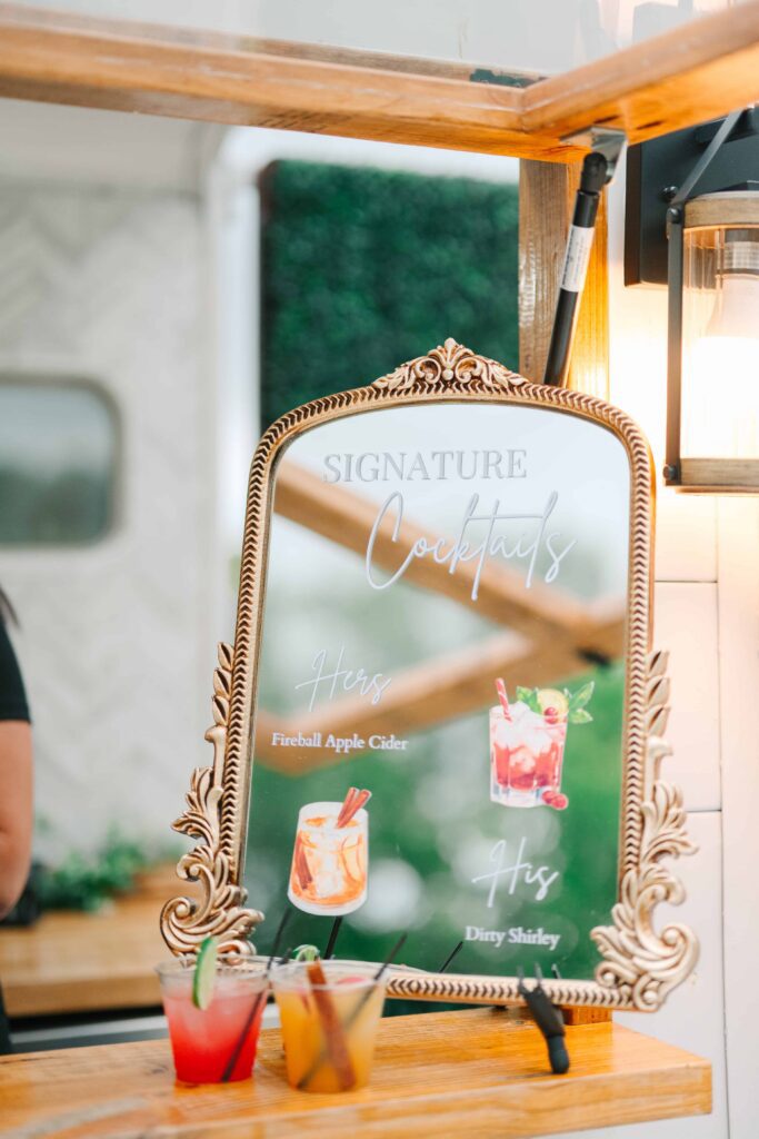 Gold mirrored signature cocktail sign displaying his and hers cocktails