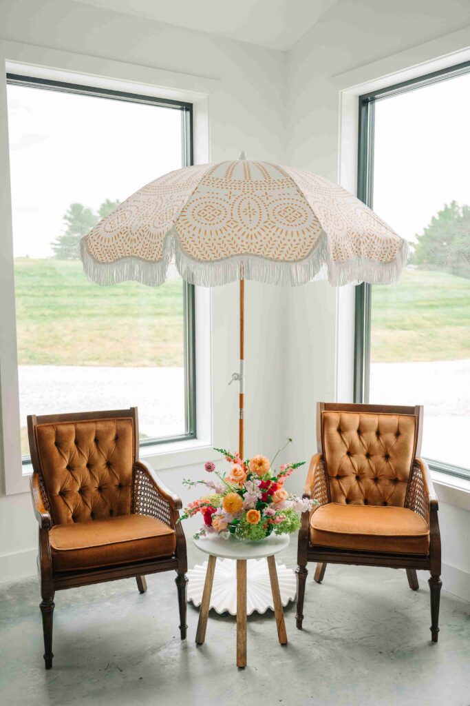 Vintage lounge chairs and beach umbrella ready for wedding guests at The Wellspring