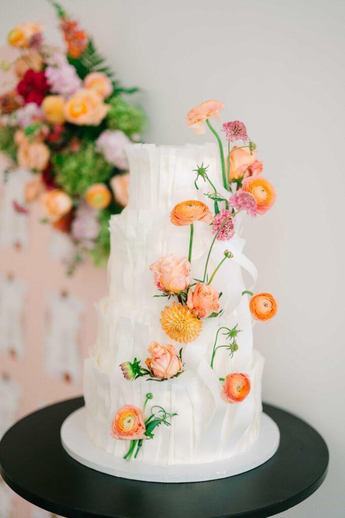 Four-tiered wedding cake with whimsical florals