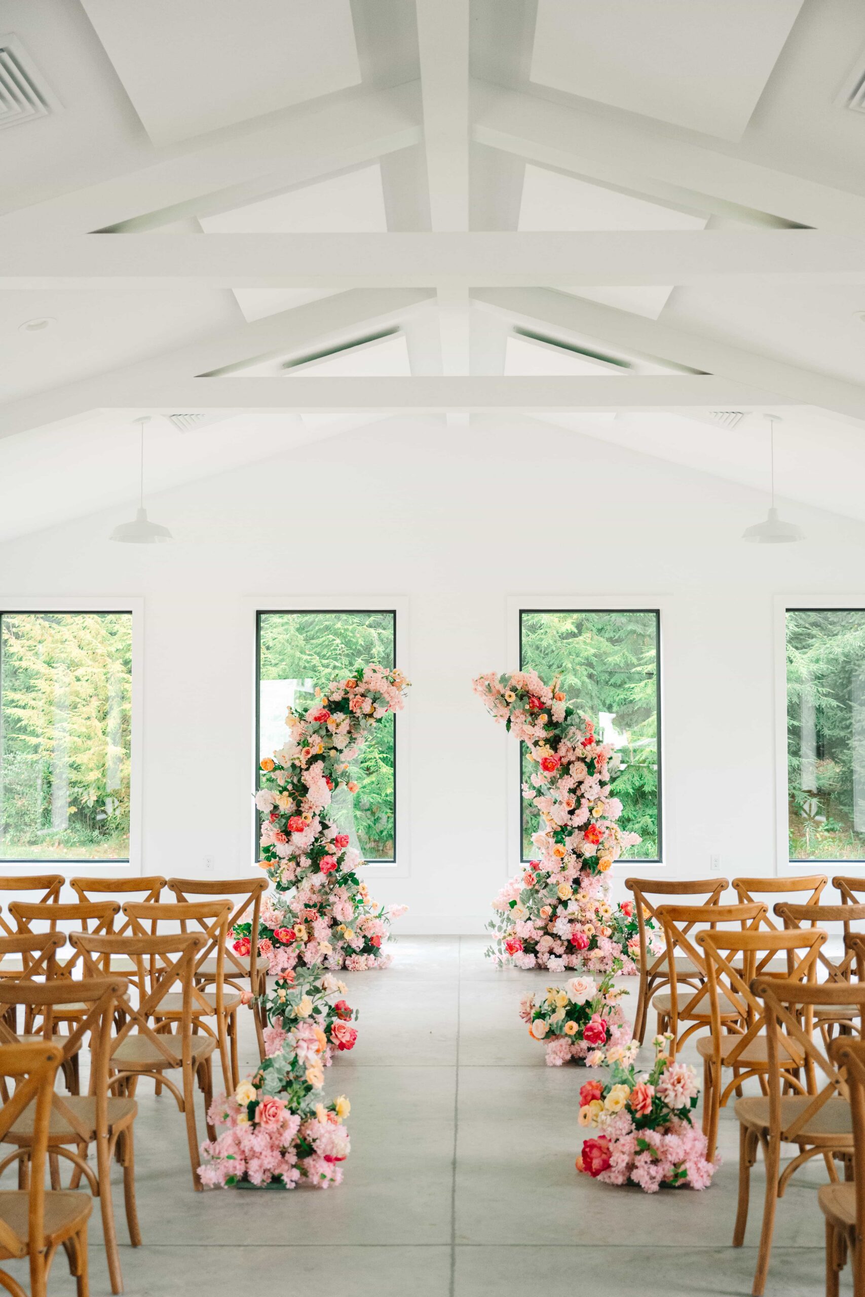 Bright, whimsical floral wedding arch for a ceremony at The Wellspring