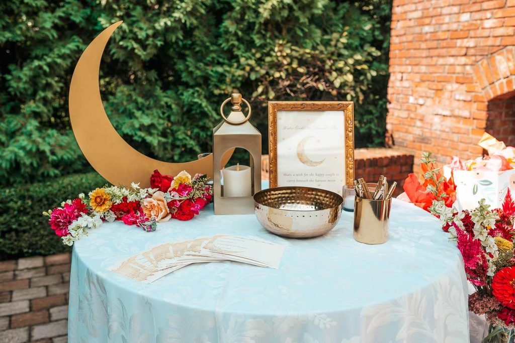Harvest moon theme bridal shower table with a sign requesting guests leave advice